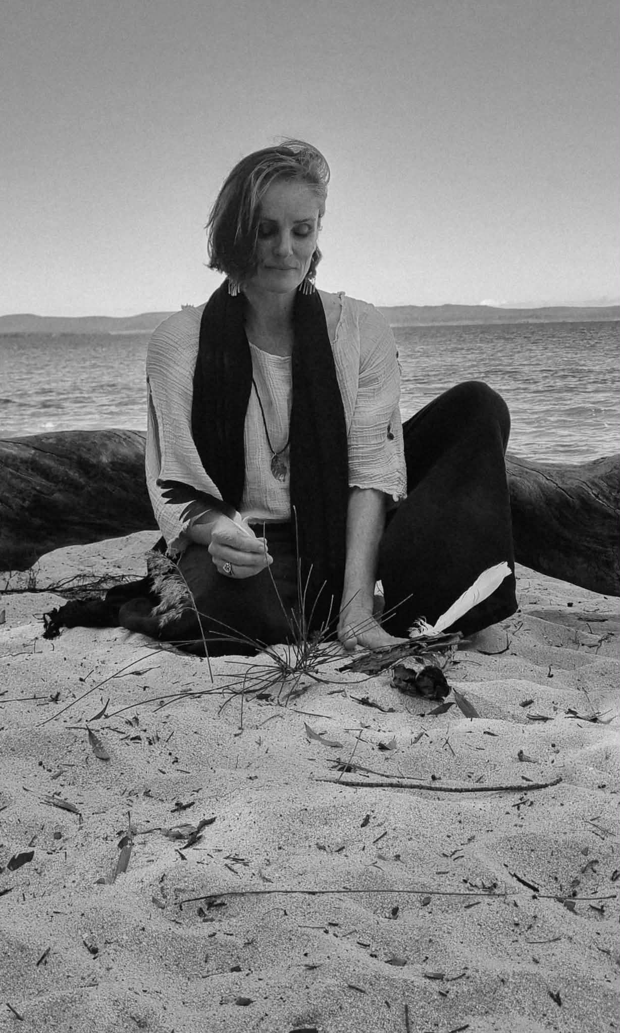 Jaime-Lee seated quietly on the beach